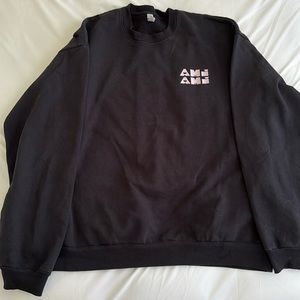 Black Sweater with light pink ‘Ami, Ami’ loosely translated to friend friend
